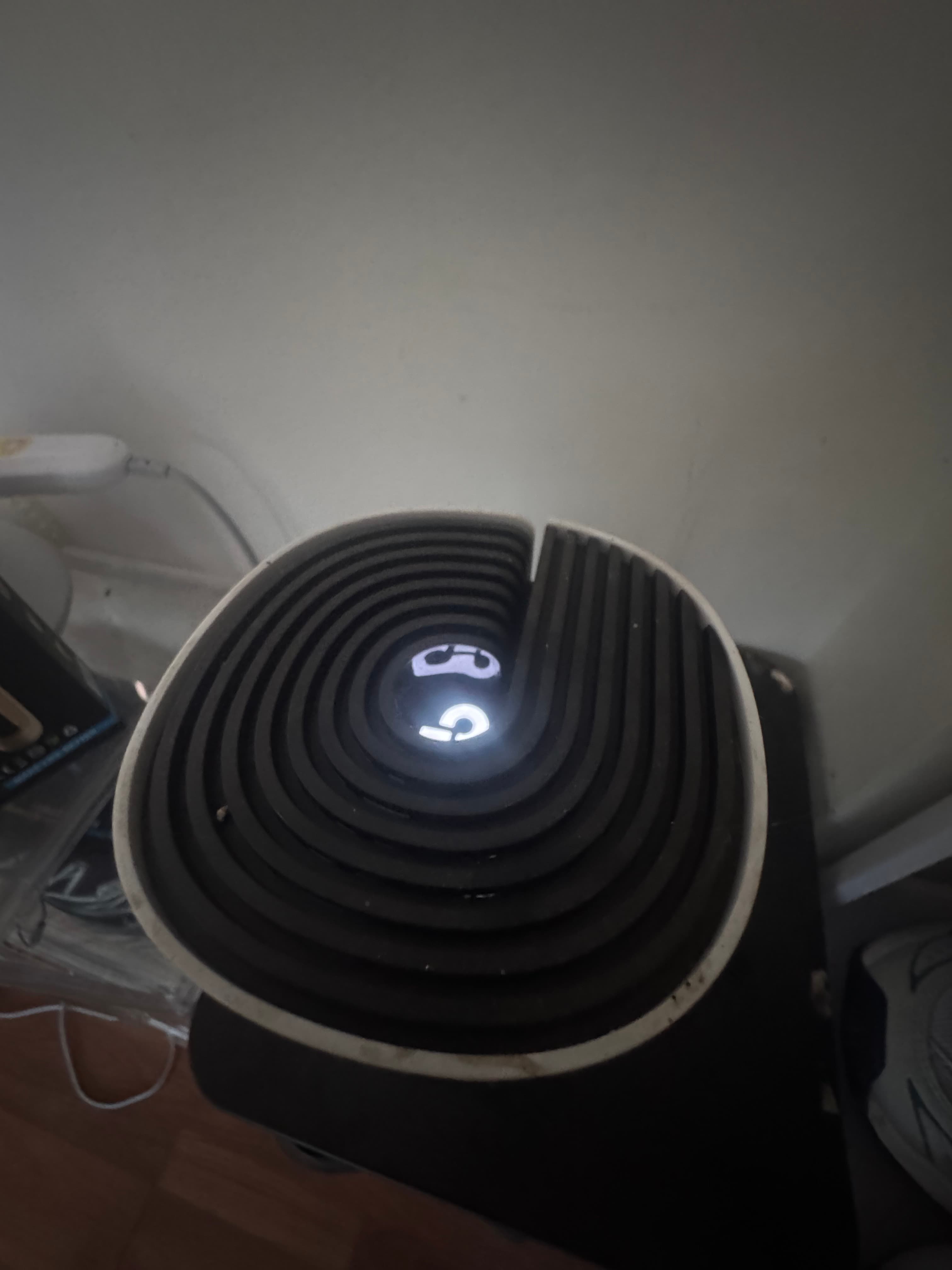 Top of the upper living room TP-Link repeater, a dark ridged bowl with a steady white logo light and no red indicator